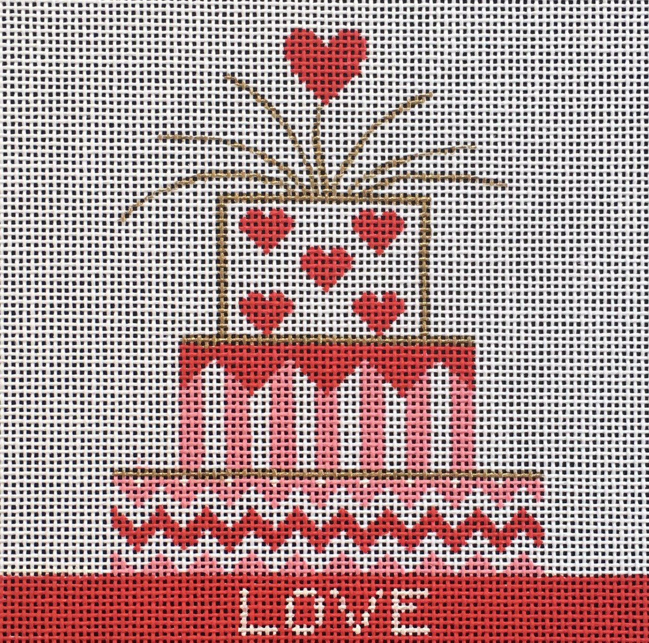 Vallerie Needlepoint Gallery needlepoint canvas of a three-tiered cake in pink white and red with a heart topper and the word love