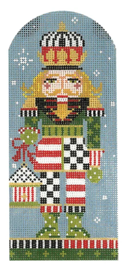 Kelly Clark Christmas needlepoint canvas of a nutcracker holding a birdhouse in the snow